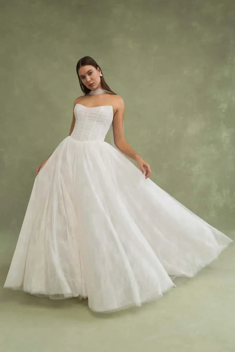 model is wearing a minimalist jenny yoo wedding dress