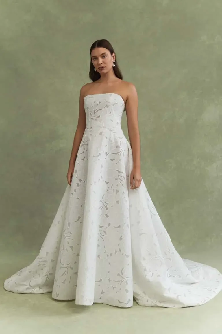 model is wearing a strapless a-line wedding gown by jenny yoo