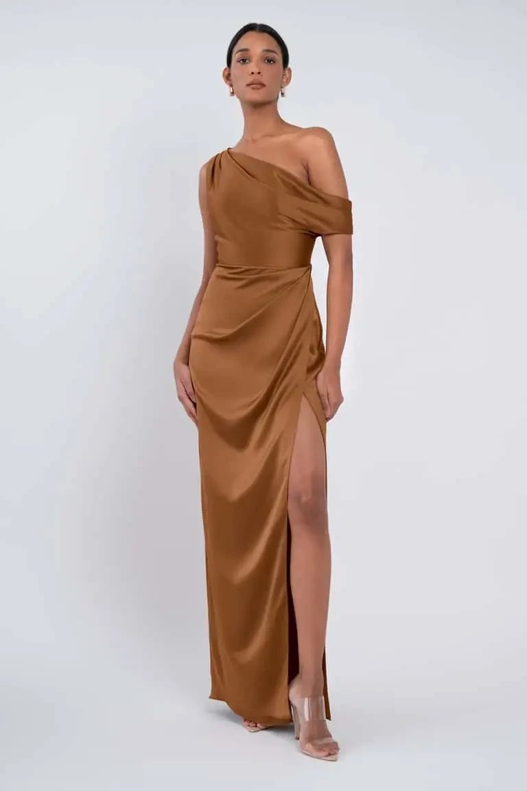 model is wearing a brown off the shoulder asymmetrical neckline bridesmaid dress