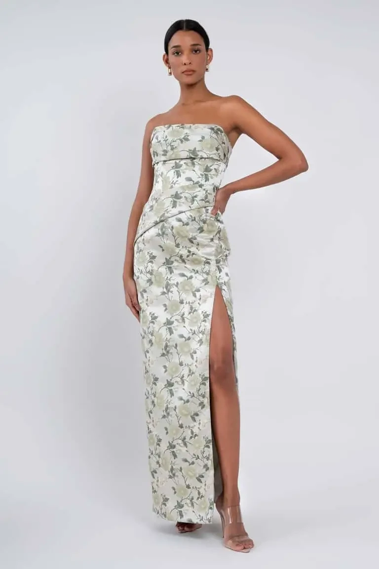 model is wearing a green floral strapless bridesmaid dress by jenny yoo