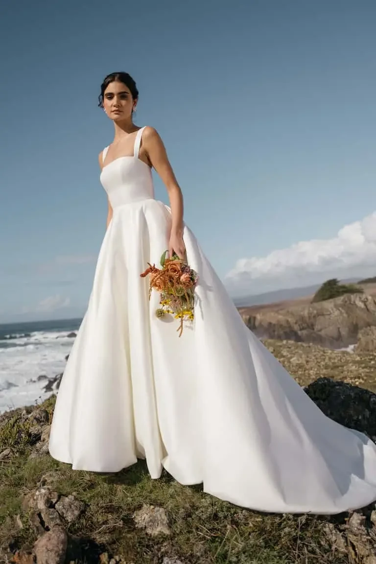 model is wearing an a-line wedding dress by jenny yoo
