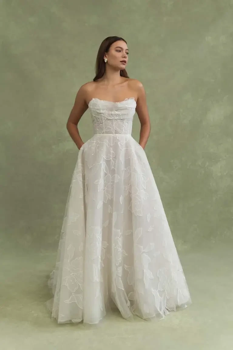 model is wearing a strapless a-line bridal gown by jenny yoo
