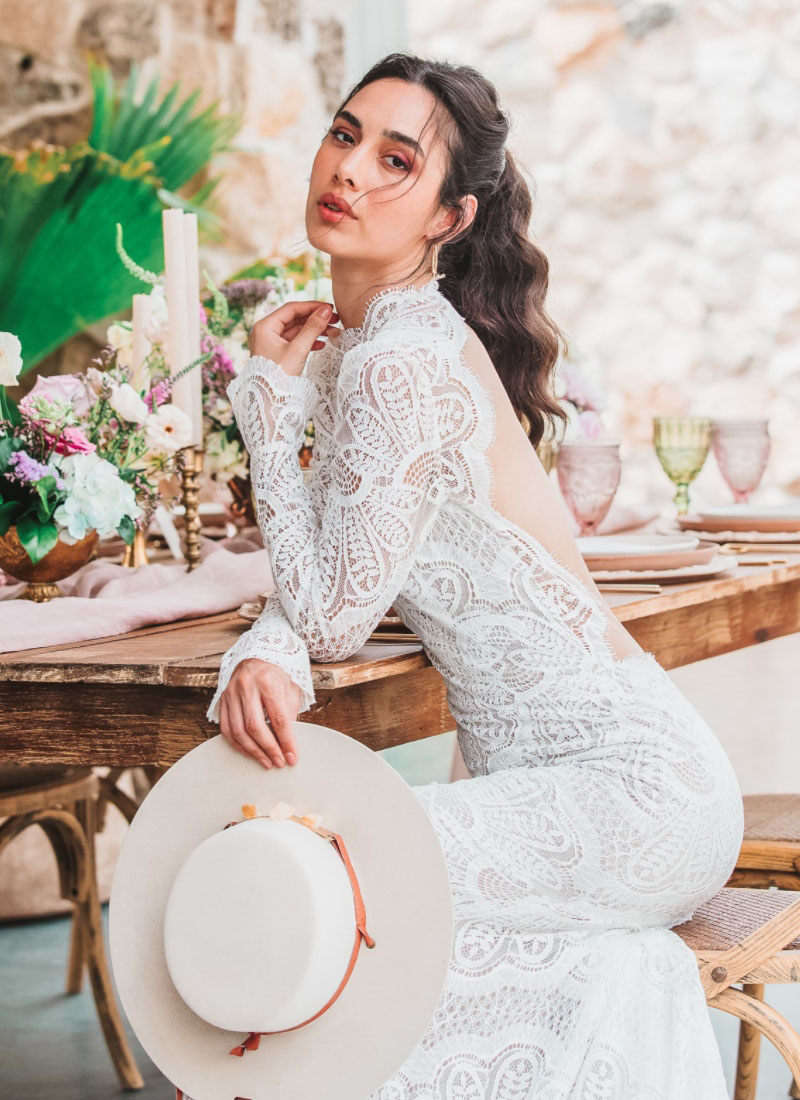 Model wearing a white gown by Willowby